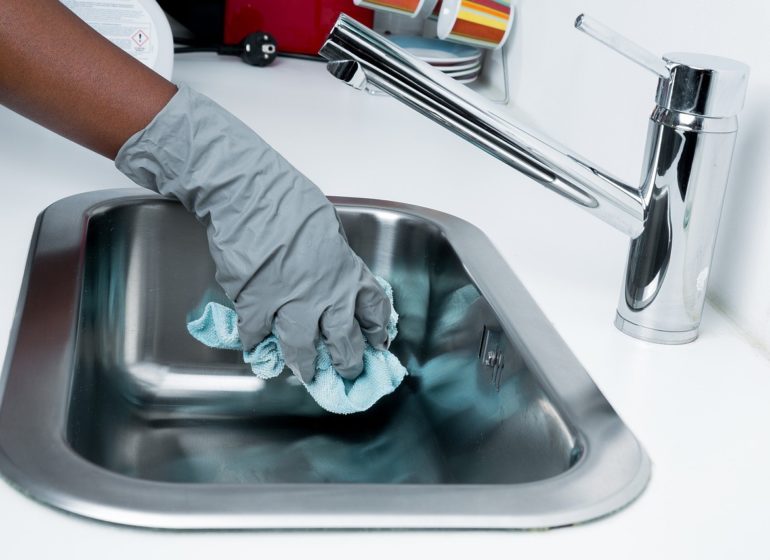 Man cleaning sink